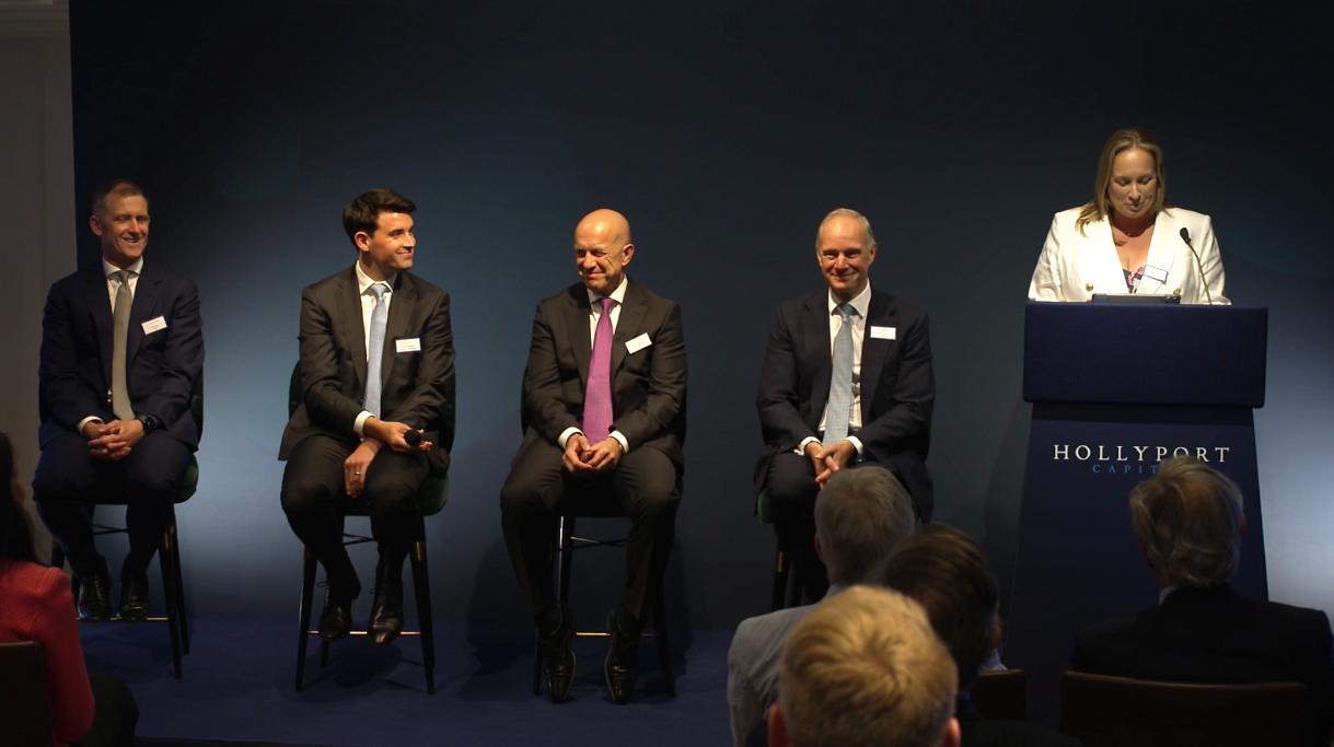 Hollyport Capital AGM: panel discussion with a speaker at the lectern