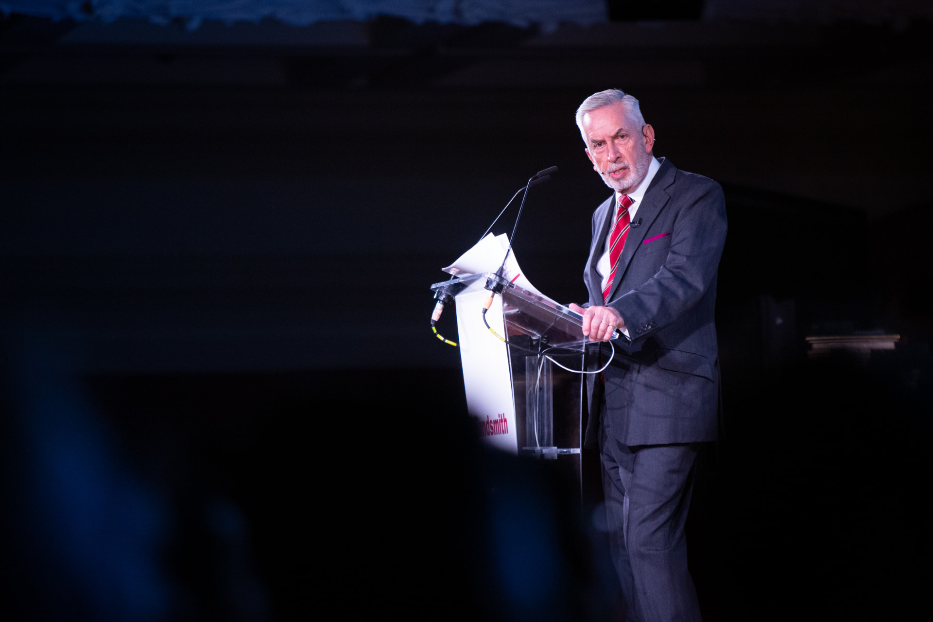 Fundsmith AGM: a speaker at the lectern on stage
