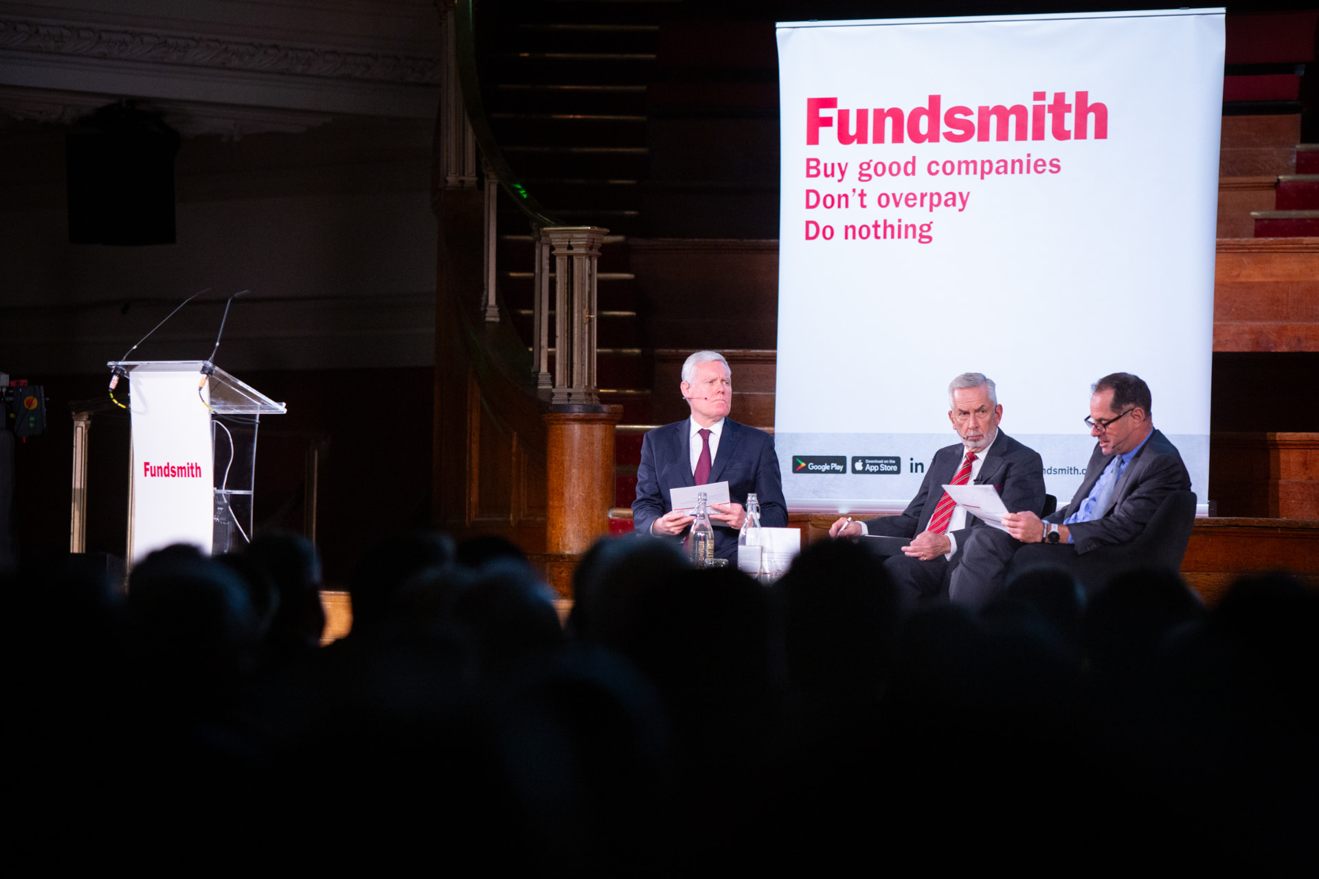 Fundsmith AGM: panel on stage in front of the Fundsmith banner